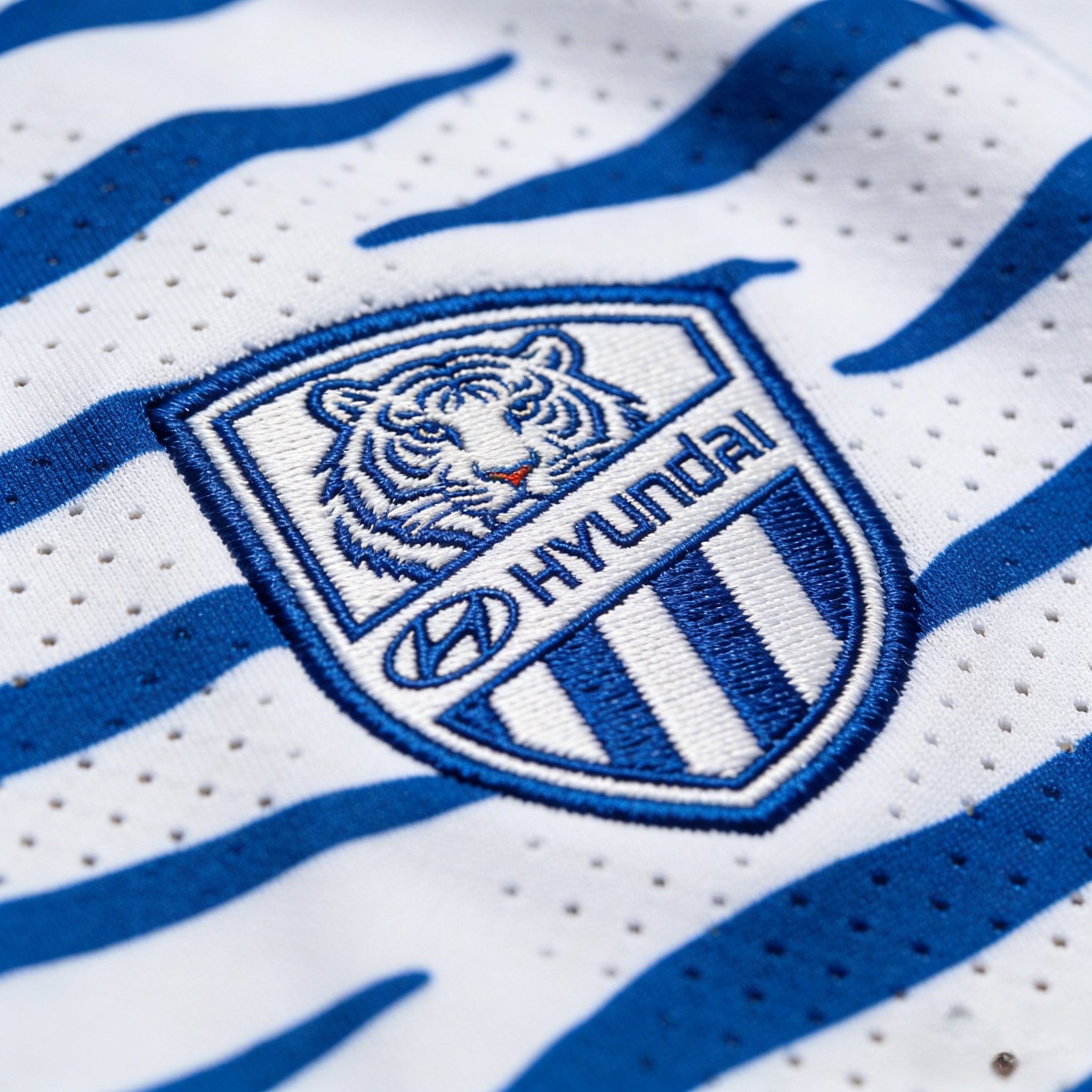 Close-up detail of Ulsan Hyundai jersey crest and performance fabric.