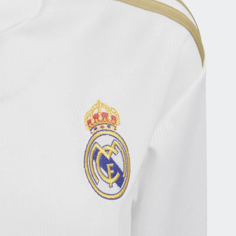 Close-up detail of the Real Madrid crest and metallic gold logos.