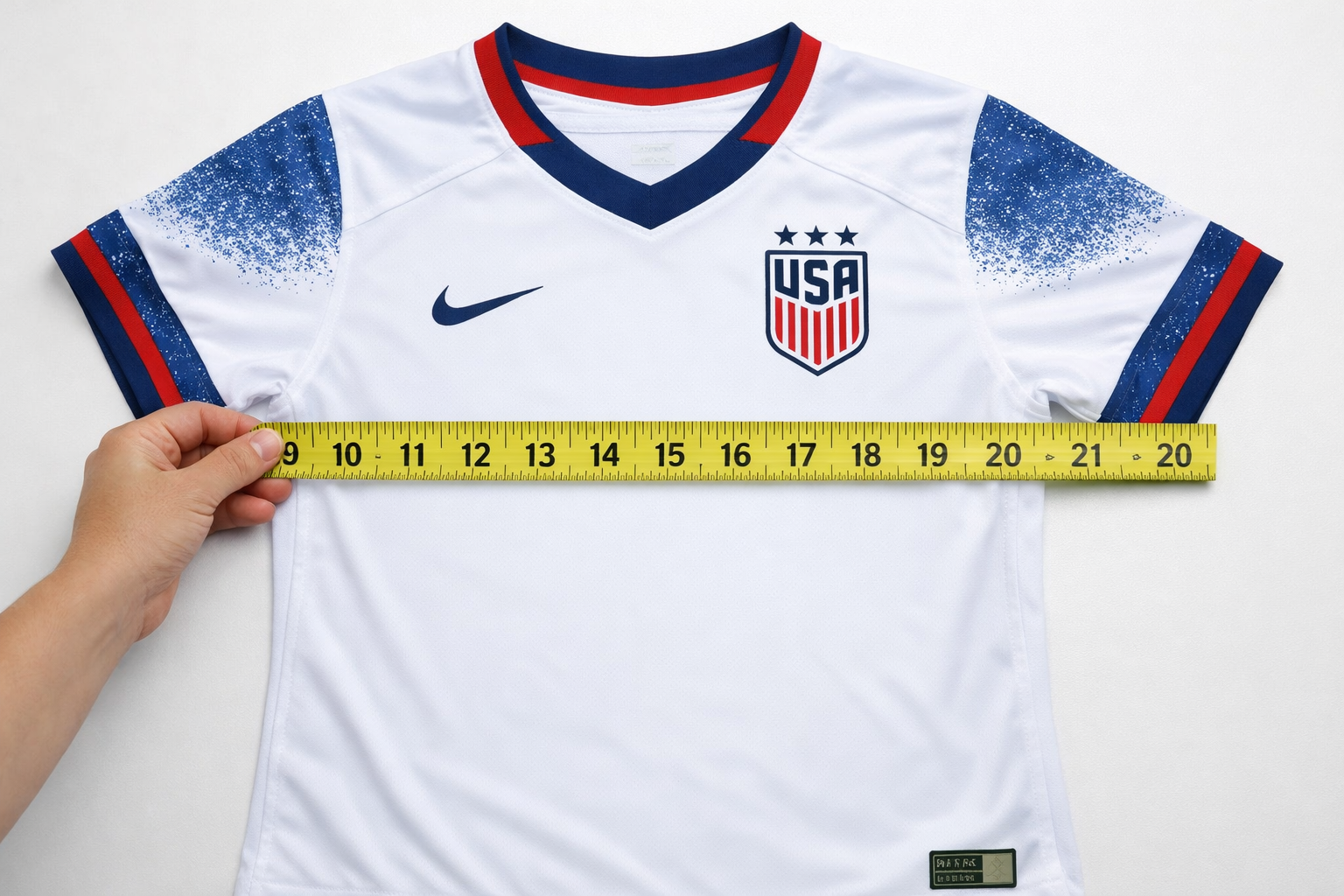 Measuring a women's soccer jersey in inches for a perfect fit.