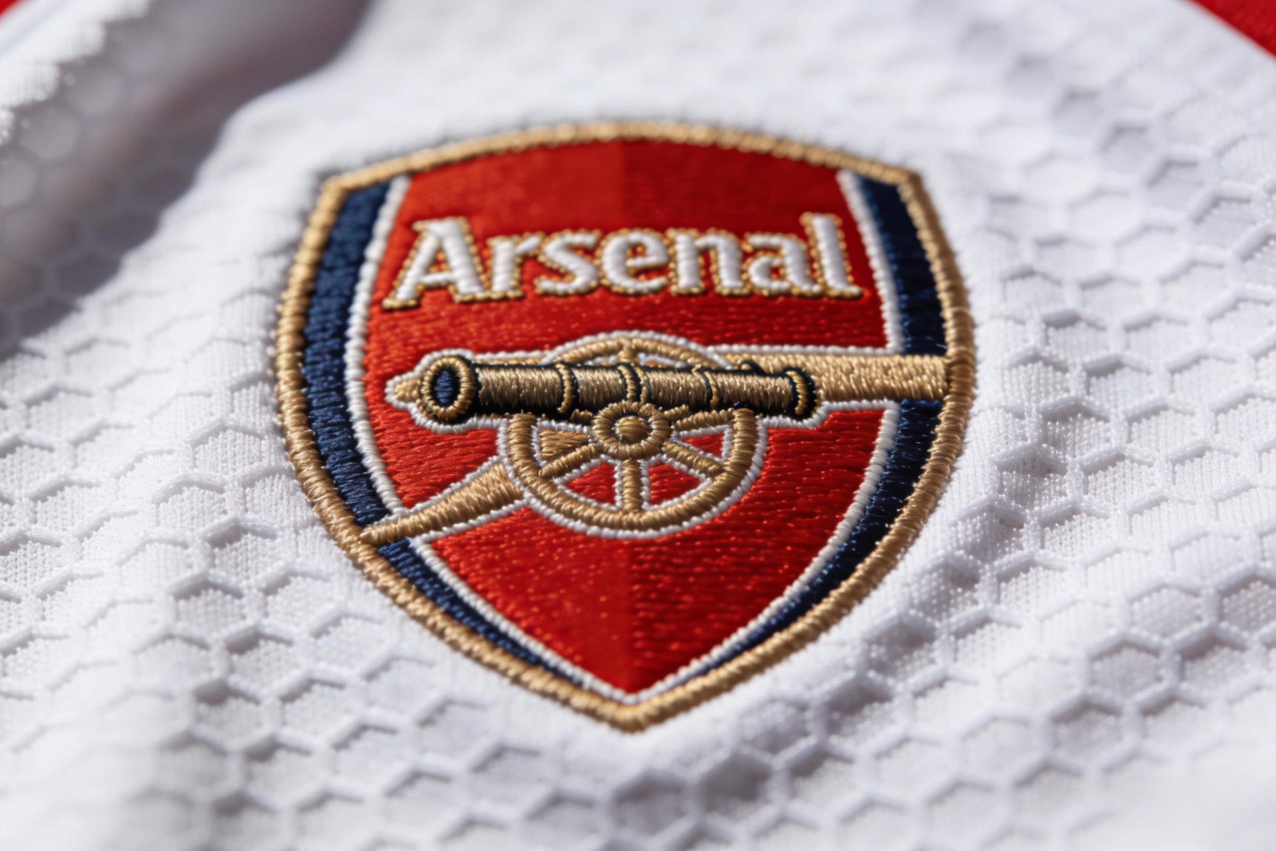 Close-up detail of Dri-FIT fabric and badge on an authentic Arsenal shirt.