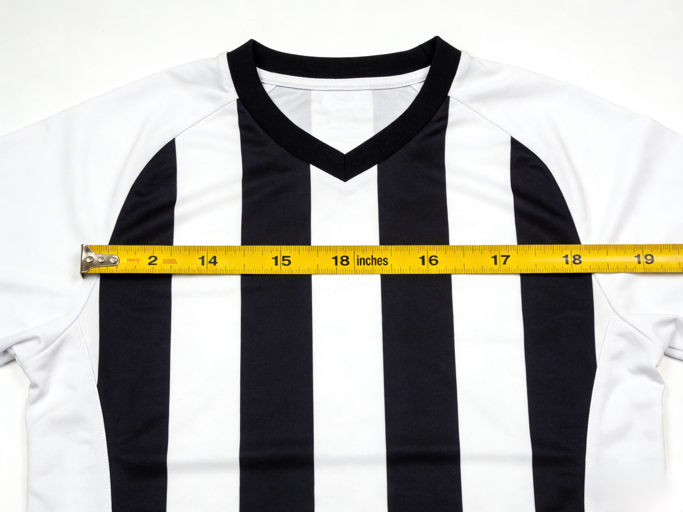  Measuring an Arsenal soccer jersey in inches for a perfect fit.